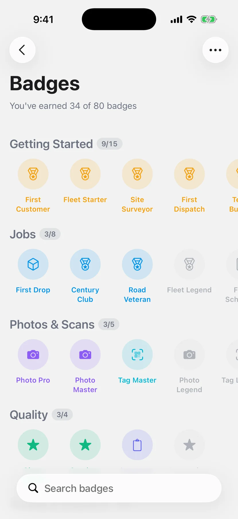 Badges earned across categories as drivers rack up XP on iOS